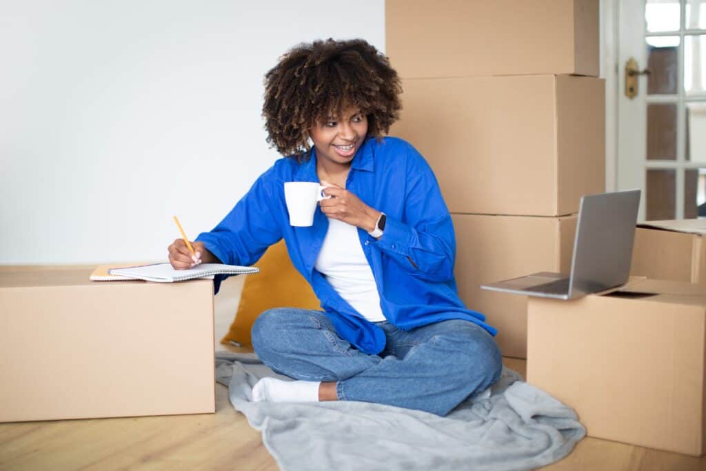A young woman is updating her checklist for the move